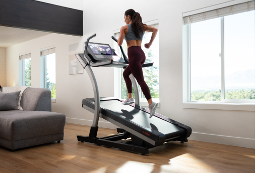 Women trainer running on a treadmill